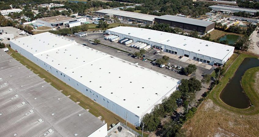 a large industrial warehouse complex with newly installed white flat roofs in Miami