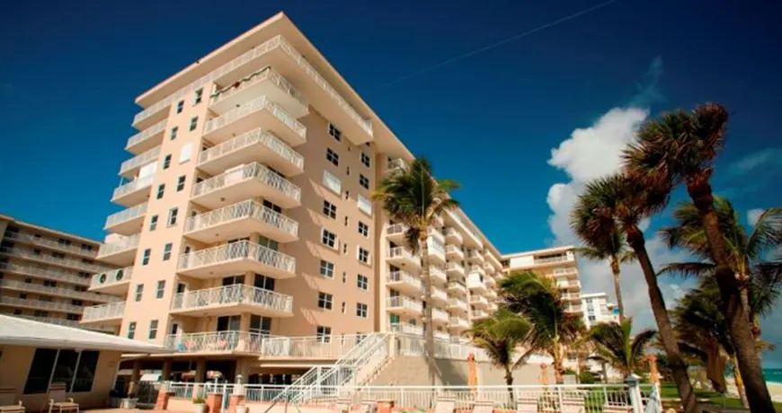 Hillsboro-Lebaron Beachfront condominium with balconies and palm trees