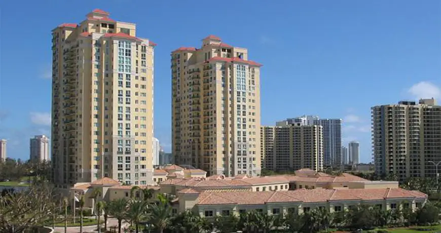 Twin high-rise residential towers with terracotta roofs in florida