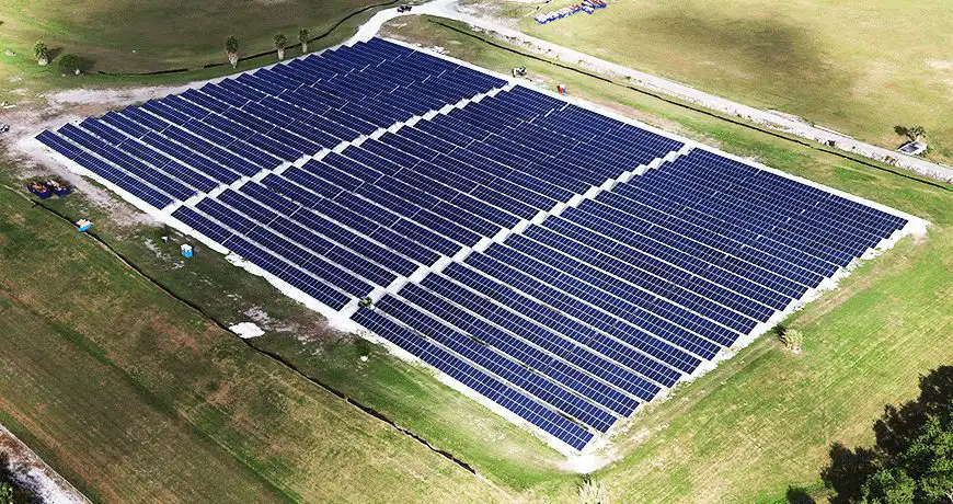Large solar farm with multiple rows of solar panels in florida