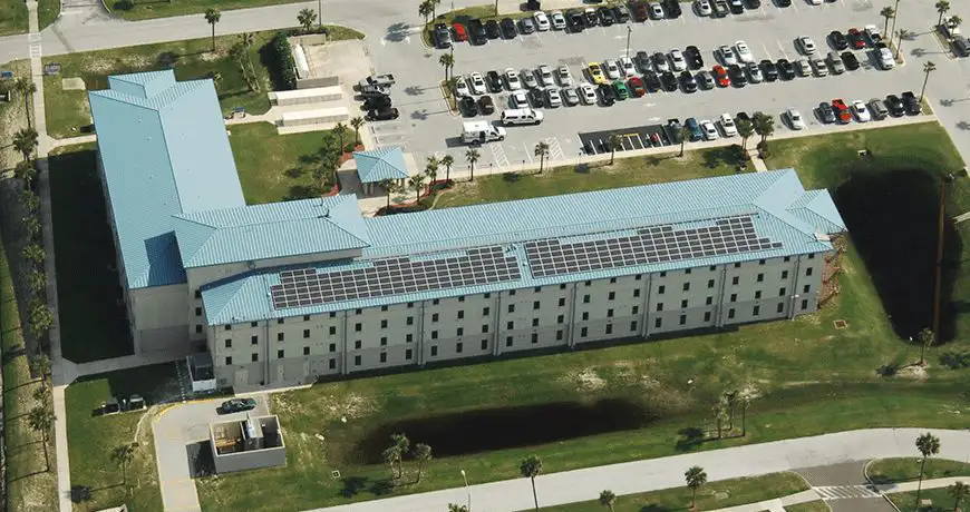 a building with a blue metal roof and solar panels in Jacksonville