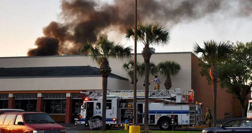 PlaneRoof Firefighters responding to a building fire with smoke rising