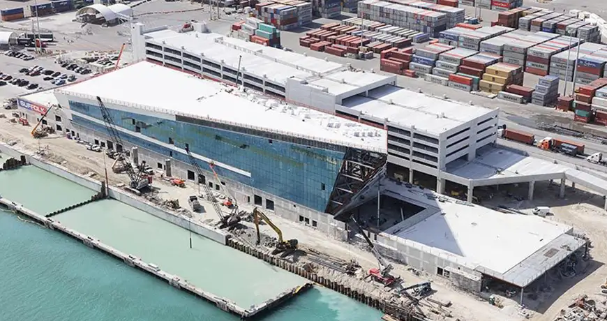 Waterfront construction site with a modern glass building in Fort Myers