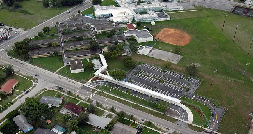 barbarah a school campus with parking and sports field