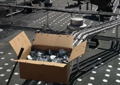 Box of fasteners on a commercial roof during installation