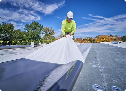 image - 2025-06-04T164748.795 Contractors laying down white TPO roofing membrane on commercial roof.
