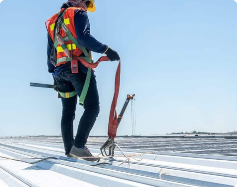 Advanced Roofing technician repairing membrane flashing on a Miami commercial roof