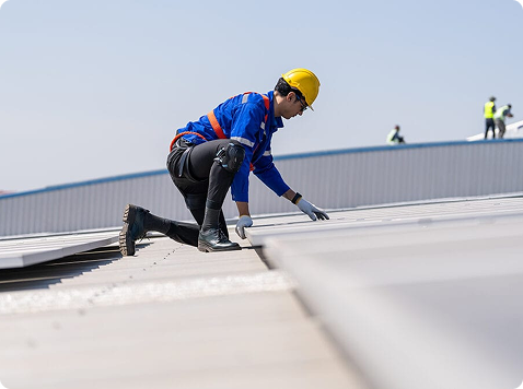 Advanced Roofing technician repairing membrane flashing on a Miami commercial roof
