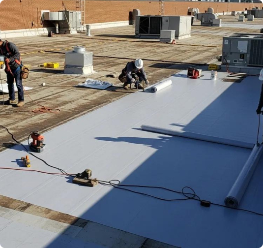 Commercial roof coating in Miami being applied to a low-slope membrane