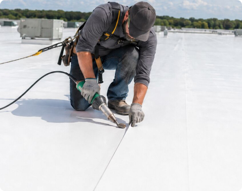 Advanced Roofing technician repairing membrane flashing on a Miami commercial roof