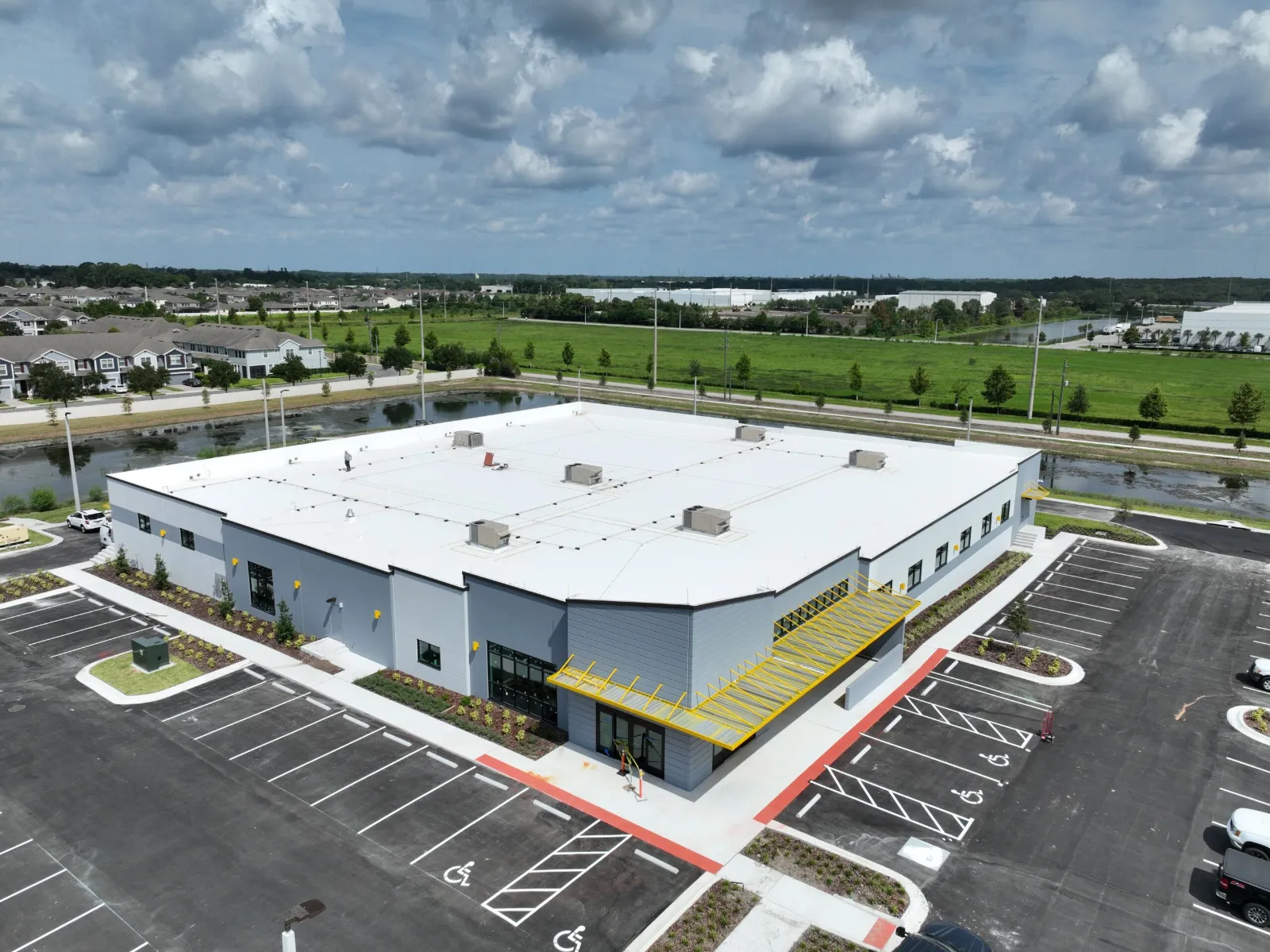 Aerial view of the HTI Hope Center in Sanford, FL with a new white single-ply commercial roof