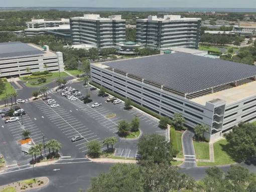 Aerial view of the Raymond James headquarters in St. Petersburg, FL with solar panel arrays covering the parking garages