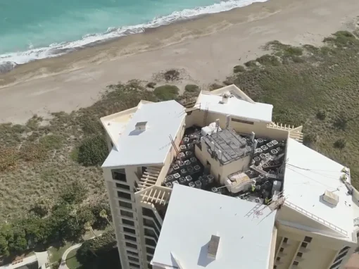 Aerial view of Sea Scape II Condominium's new white roof beside the beach in Fort Pierce, FL