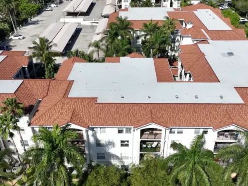 Aerial view of Tuscany on the Intracoastal in Boynton Beach, FL showing new white flat roof sections framed by terracotta tile roofs