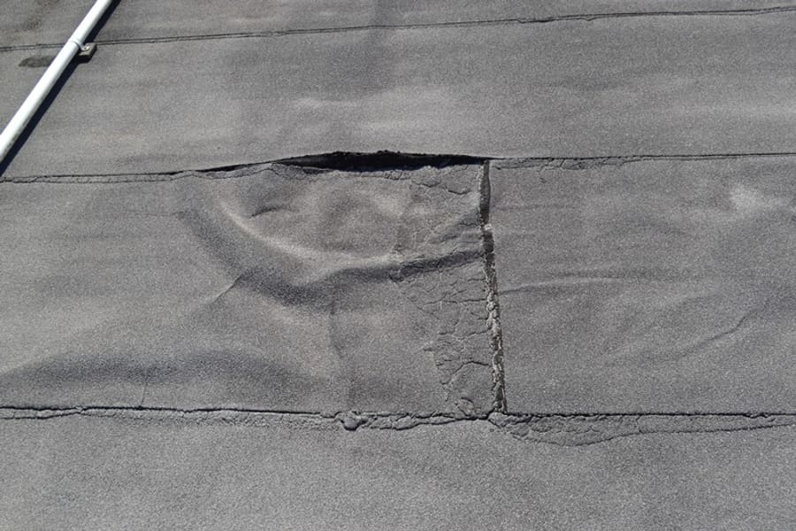 Open lap seam in a modified bitumen roof membrane